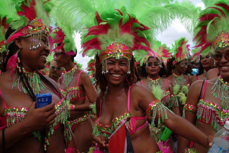 Colorful carnival performers in pink and green costumes