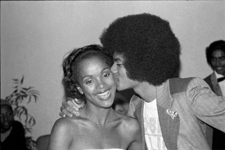 Man kissing smiling woman on the cheek